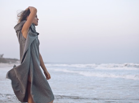 young pretty woman in sweater at seacoast walking relaxing, fashion ladyの写真素材