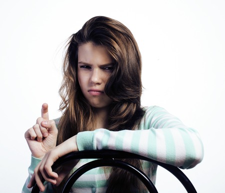 Teenage Girl Looking Worried isolated on white background, sad teen close upの写真素材