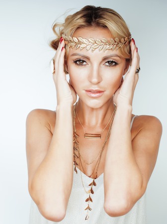 young blond woman dressed like ancient greek godess, gold jewelry close up isolated, beautiful girl hands manicured red nailsの写真素材