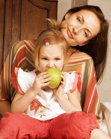 young mother with daughter at home playing, happy familyの写真素材