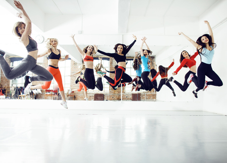 Women doing sport in gym, healthcare lifestyle people concept, modern loft studio, cheerful smiling girlsの写真素材