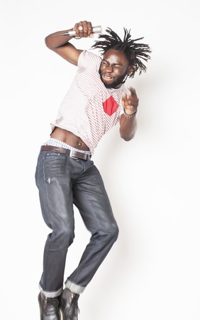 young handsome african american boy singing emotional with microphone isolated on white background, in motion gesturing smiling, lifestyle people conceptの写真素材