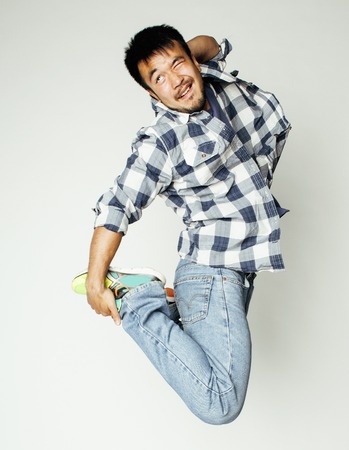 young pretty asian man jumping cheerful against white background, lifestyle people concept, super guyの写真素材
