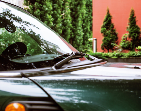 vintage car detail, concept of British Patriotism shown as flag on mirror, trees in reflection windshield, body partの写真素材
