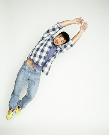 young pretty asian man jumping cheerful against white background, lifestyle people conceptの写真素材