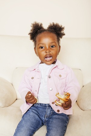 litle cute sweet african-american girl playing happy with toys at home, lifestyle children conceptの写真素材