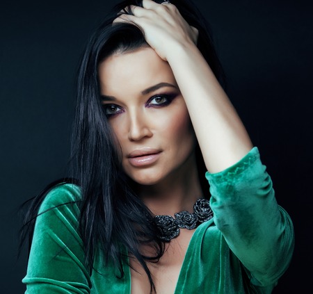 young pretty brunette woman fashion dressed, bright makeup, elegant hair style close upの写真素材