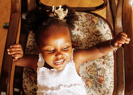 litle cute sweet african-american girl playing happy with toys at home, lifestyle children conceptの写真素材