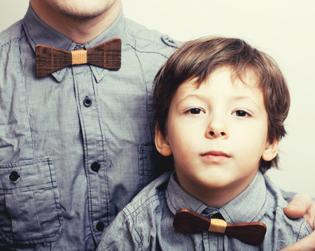 father with son in bowties on white background, casual look familyの写真素材