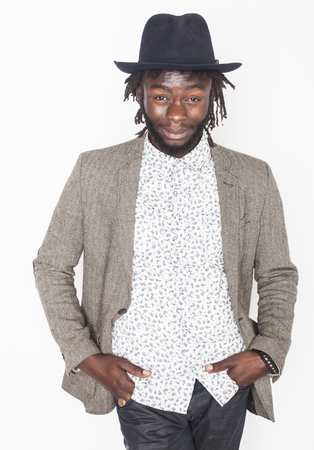 young handsome afro american boy in stylish hipster hat gesturing emotional isolated on white background fooling aroundの写真素材