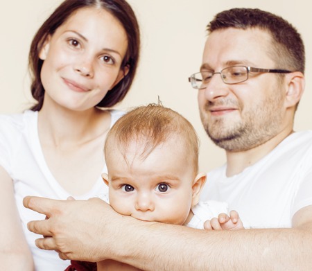 young happy modern family smiling together at home. lifestyle people concept, father holding baby...