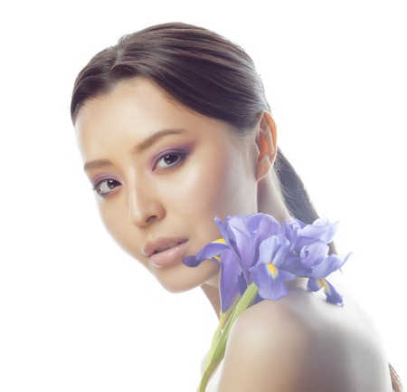 young pretty real asian woman with flower purple orchid close up isolated on white background spa,...