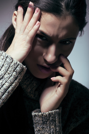 young pretty woman in trouble, screaming in grief close up depressed winter, dark sadness concept close upの写真素材