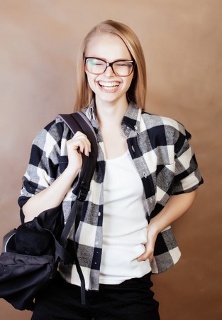 young happy smiling hipster blond girl with backpack ready to school, teenage lifestyle people concept close upの写真素材