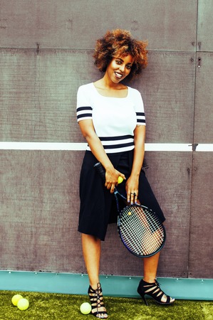 young stylish mulatto afro-american real girl playing tennis, sport healthy lifestyle people conceptの写真素材