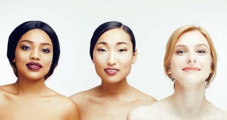 three different nation woman: asian, african-american, caucasian together isolated on white background happy smiling, diverse type on skin, lifestyle people concept close upの写真素材