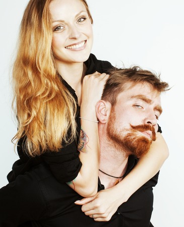 young tender couple, man and woman in love isolated on white, fooling around real modern hipster marriage conceptの写真素材