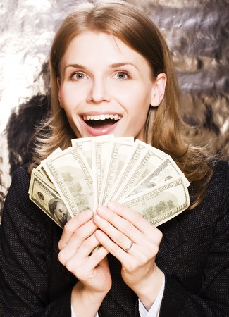 pretty young brunette real modern woman with money cash isolated on white background happy smiling, lifestyle people concept close upの写真素材