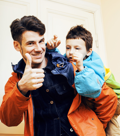 young handsome father with his son fooling around at home, lifestyle people concept close upの写真素材