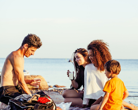 pretty diverse nation and age friends on sea coast having fun, lifestyle people concept on beach vacations close upの写真素材