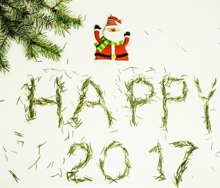 happy new year design on white background with pine tree and text close upの写真素材