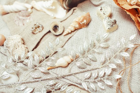 a lot of sea theme in mess like shells, candles, perfume, girl stuff on linen, pretty textured post card view vintageの写真素材