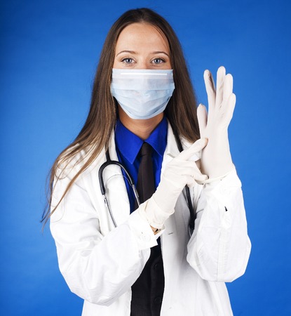 young pretty woman doctor with stethoscope wearing maskの写真素材