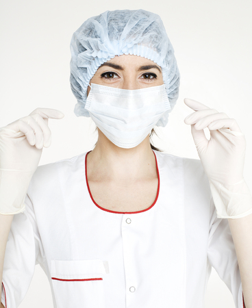 young pretty woman doctor with stethoscope wearing maskの写真素材