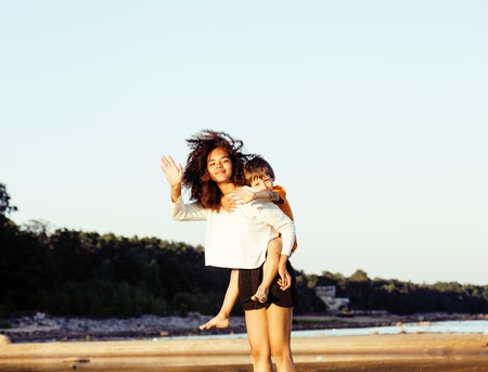 pretty diverse nation and age friends on sea coast having fun, lifestyle people concept on beach vacationsの写真素材