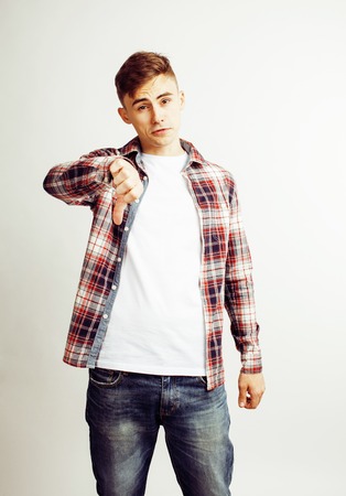 young handsome teenage hipster guy posing emotional, happy smiling against white background isolated, lifestyle people conceptの写真素材