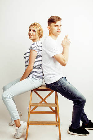 young pretty teenage couple, hipster guy with his girlfriend happy smiling and hugging isolated on white background, lifestyle people conceptの写真素材