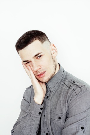 young handsome well-groomed guy posing emotional on white background, lifestyle people concept