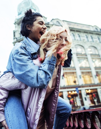 Two teenage girls infront of university building smiling, havingの写真素材
