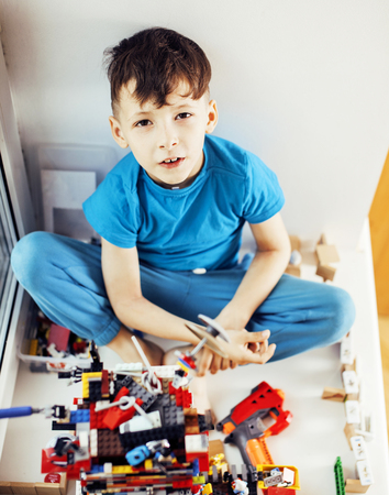 little cute preschooler boy playing lego toys at home happy smilの写真素材