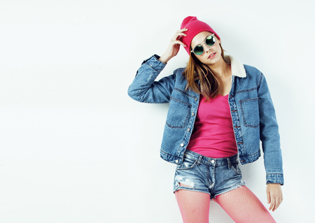 young pretty teenage hipster girl posing emotional happy smiling on white background, lifestyle people concept close upの写真素材