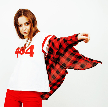 young pretty teenage hipster girl posing emotional happy smiling on white background, lifestyle people conceptの写真素材