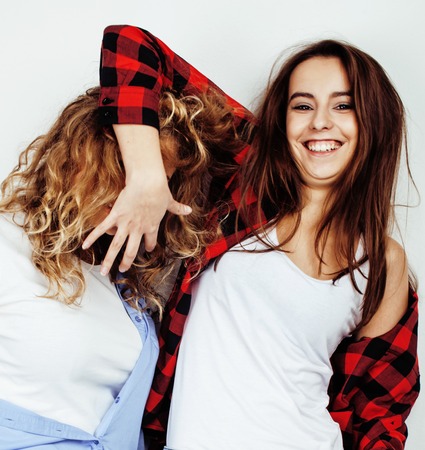 best friends teenage girls together having fun, posing emotional on white background, besties happy smiling, lifestyle people conceptの写真素材