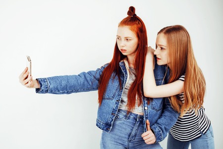 best friends teenage girls together having fun, posing emotional on white background, besties happy smiling, lifestyle people conceptの写真素材