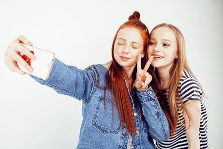 lifestyle people concept: two pretty stylish modern hipster teen girl having fun together, happy...