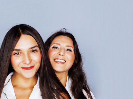 cute pretty teen daughter with mature mother hugging, fashion stの写真素材