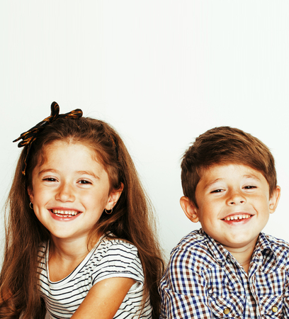 little cute boy and girl hugging playing on white background, haの写真素材