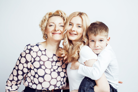 happy smiling family together posing cheerful on white background, lifestyle people concept, mother with son and teenage daughter isolatedの写真素材