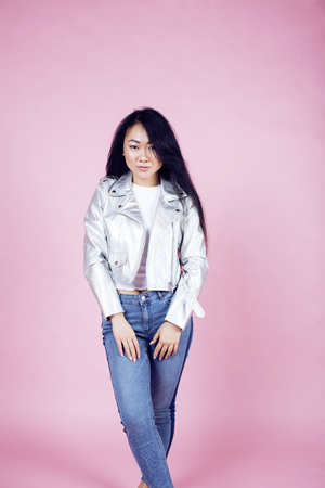 young pretty smiling asian korean girl wearing modern fashion clothers on pink background, lifestyle people concept closeupの写真素材