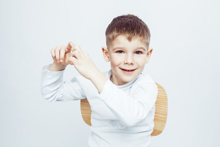 little cute adorable boy posing gesturing cheerful on white background, lifestyle people concept closeupの写真素材