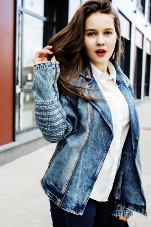 young pretty hipster girl student with coffee cup posing adorable smiling, lifestyle people concept outdoorの写真素材