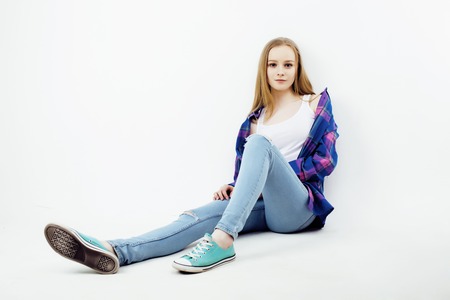 young pretty teenage hipster girl posing emotional happy smiling on white background, lifestyle people conceptの写真素材