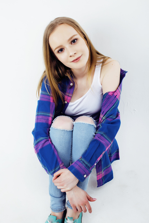 young pretty teenage hipster girl posing emotional happy smiling on white background, lifestyle people conceptの写真素材