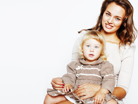 young pretty stylish mother with little cute blond daughter huggの写真素材