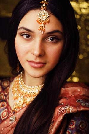 beauty sweet real indian girl in sari smiling on black backgrounの写真素材