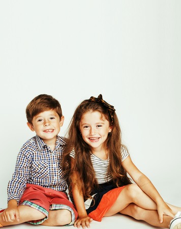 little cute boy and girl hugging playing on white background, haの写真素材